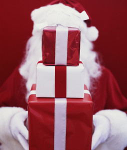 Santa Holding Stack of Gifts --- Image by © Royalty-Free/Corbis